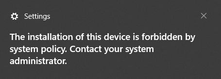 Windows error message indicating device installation is blocked due to an enforced system or group policy.